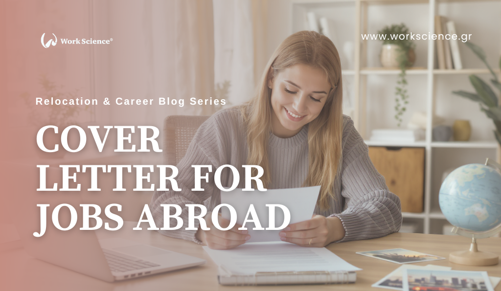 A young woman smiling while reviewing documents at a desk with a laptop, a globe, and printed photos spread out.
