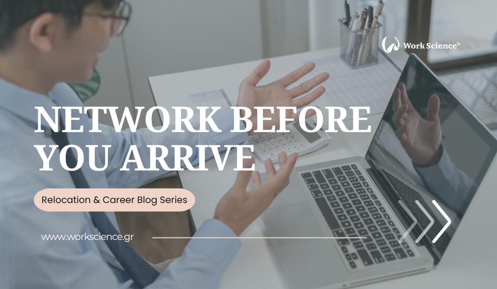 A man sits at a desk, gesturing with open hands while looking at a laptop, symbolizing the active process of professional networking that should occur before relocating.