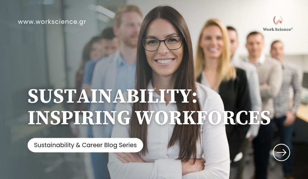 A diverse group of young professionals stands in an office setting, with a smiling woman in glasses at the forefront, representing a motivated, modern workforce that is inspired by sustainability goals.