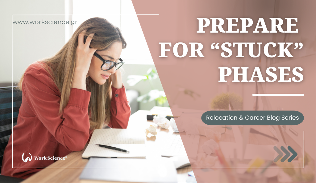 **Alt text:** Stressed young woman in glasses holding her head while working at a desk with papers and a notebook. Text overlay reads: “Prepare for ‘Stuck’ Phases – Relocation & Career Blog Series” by Work Science.