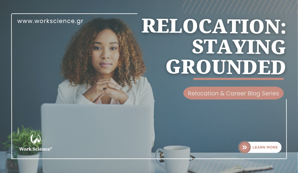 Here’s a concise, clear alt text for the image: **Alt text:** A woman sitting at a desk with a laptop, looking thoughtful and focused, symbolizing staying grounded during relocation and major transitions.